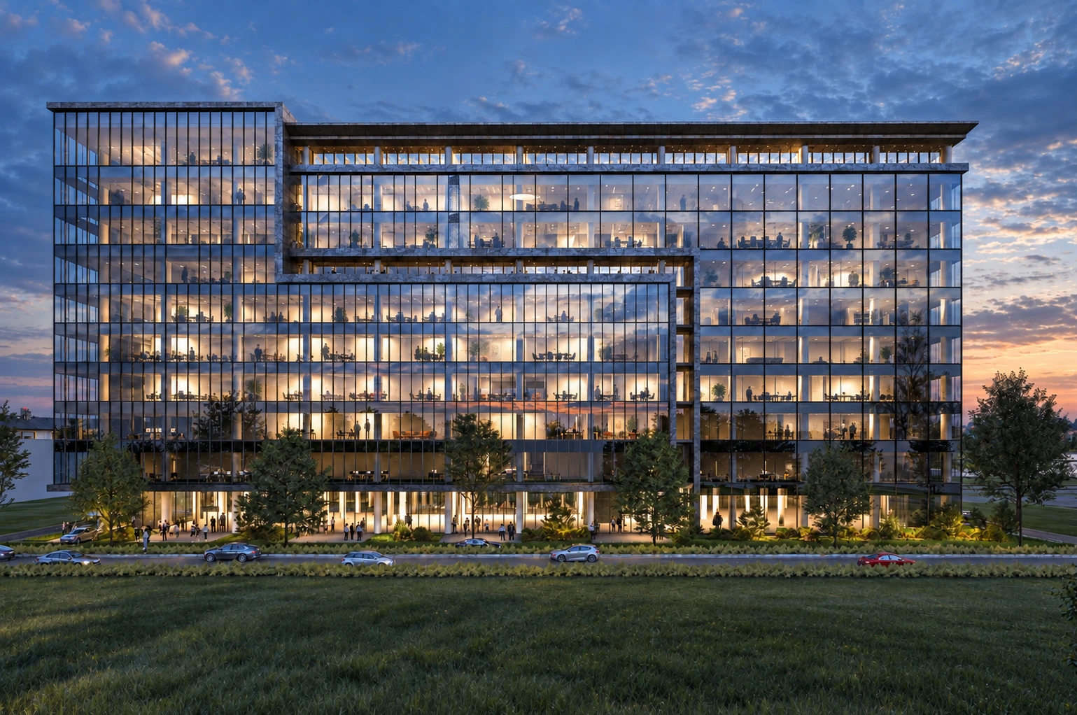 Glazed office building at dusk with subtly furnished and occupied interiors